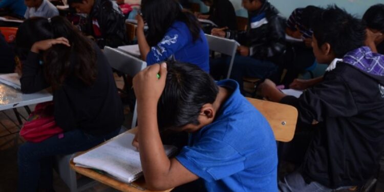 Estudiantes en un aula realizando una prueba estandarizada.