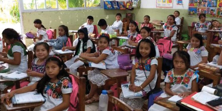 Niños y niñas migrantes en aula bilingüe enfrentan desafíos educativos y de derechos en contextos de deportación y retorno.